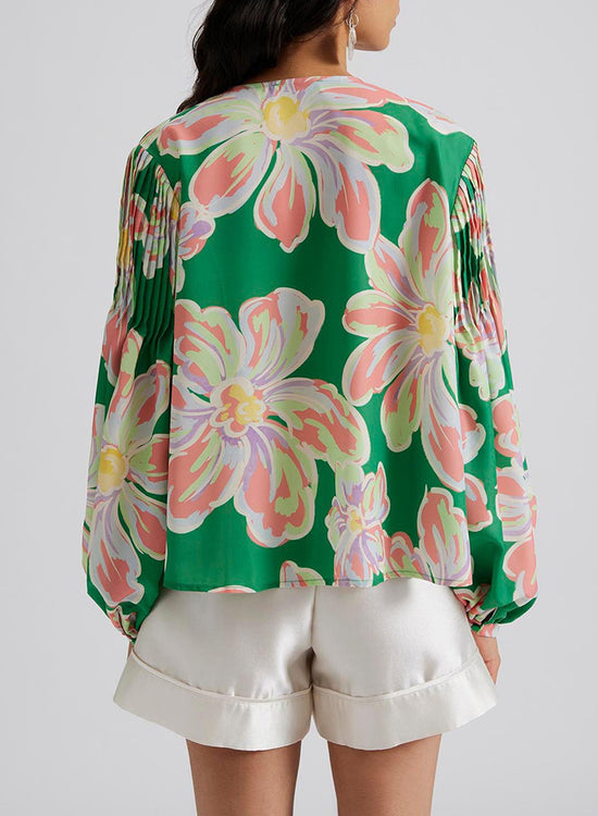 Large folded shirt with puffy sleeves and green floral print button