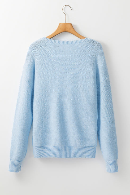 Light blue knitted sweater with ribbed edges with flowers pattern