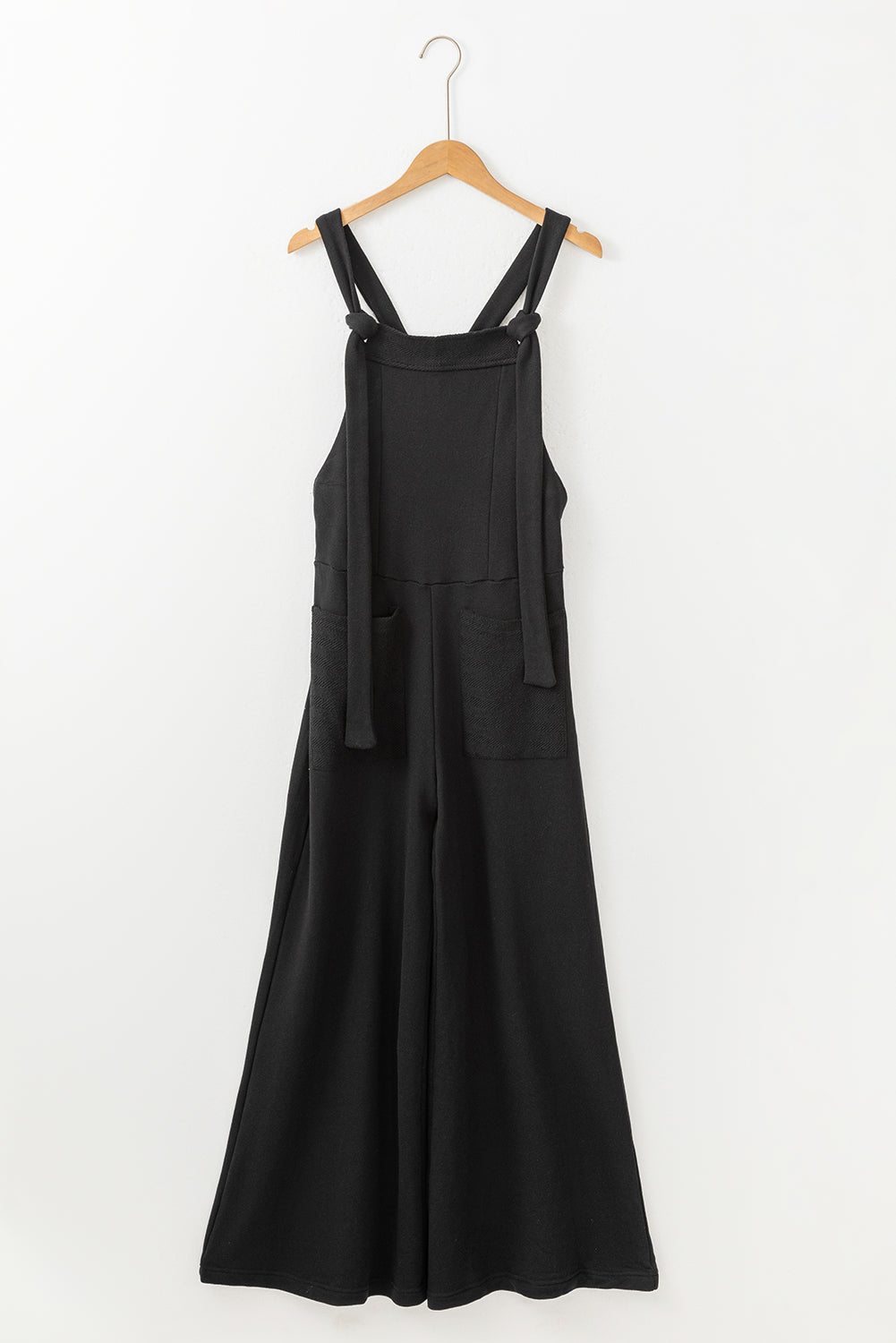 Black wide leg jumpsuit with knotted straps and patch pocket