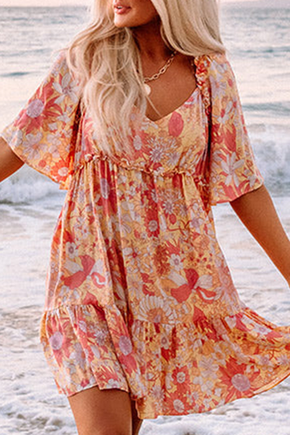 Orange floral dress with wide, flowing sleeves