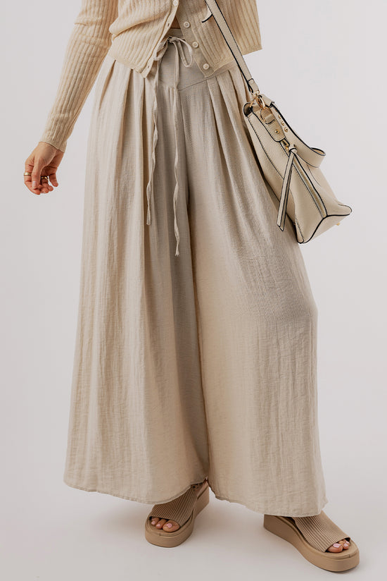 Large pleated leg relaxed pants with beige tightening cord