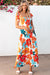 Long orange floral dress with straps tied at the smocked bust