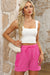 Large shorts with bright pink cargo pocket