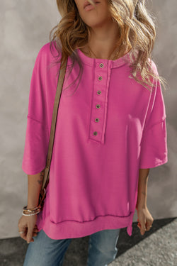 High tunic with wide sleeves and buttoned collar with apparent red pink seams