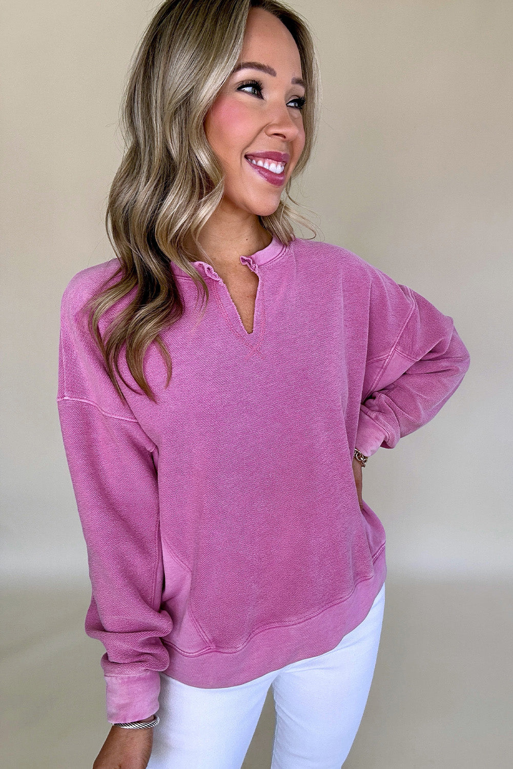 Hot pink sweatshirt with dropped shoulders and solid color notched collar