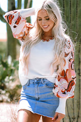White sweater with bishop sleeves and floral patch