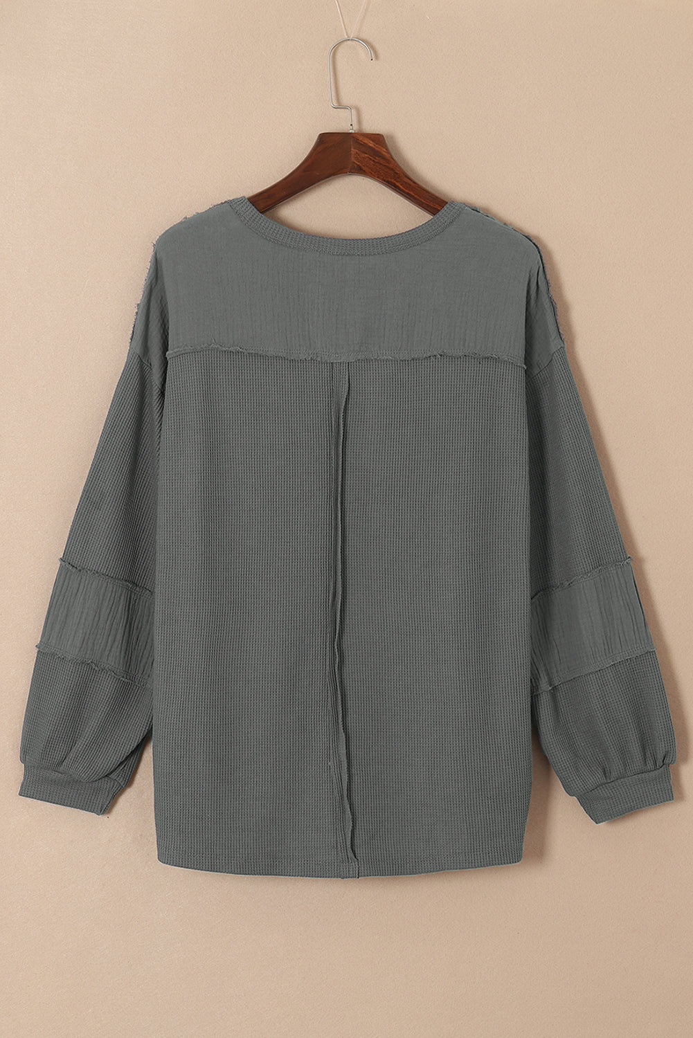 Grey waffle knit top with bubble sleeves and patchwork with exposed seams