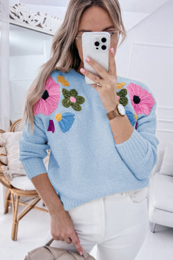 Light blue knitted sweater with ribbed edges with flowers pattern