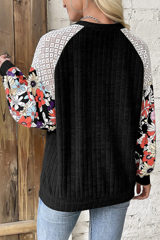 Black ribbed blouse with long sleeves and floral patchwork