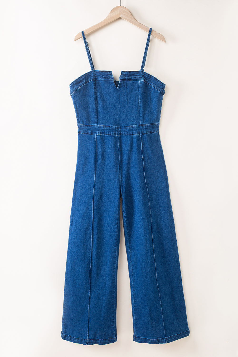 Blue denim jumpsuit with thin straps and V-notch