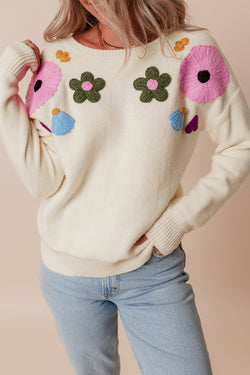 Beige knitted sweater with ribbed edges with flower pattern