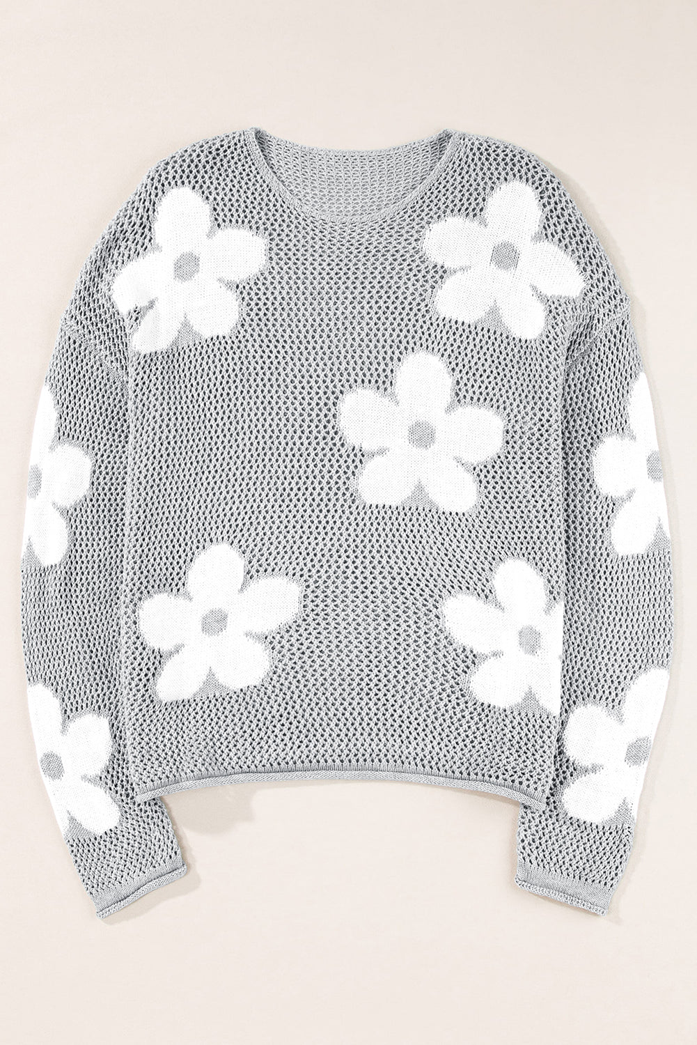 Light gray sweater with drooping shoulders in openwork knitting with large flowers