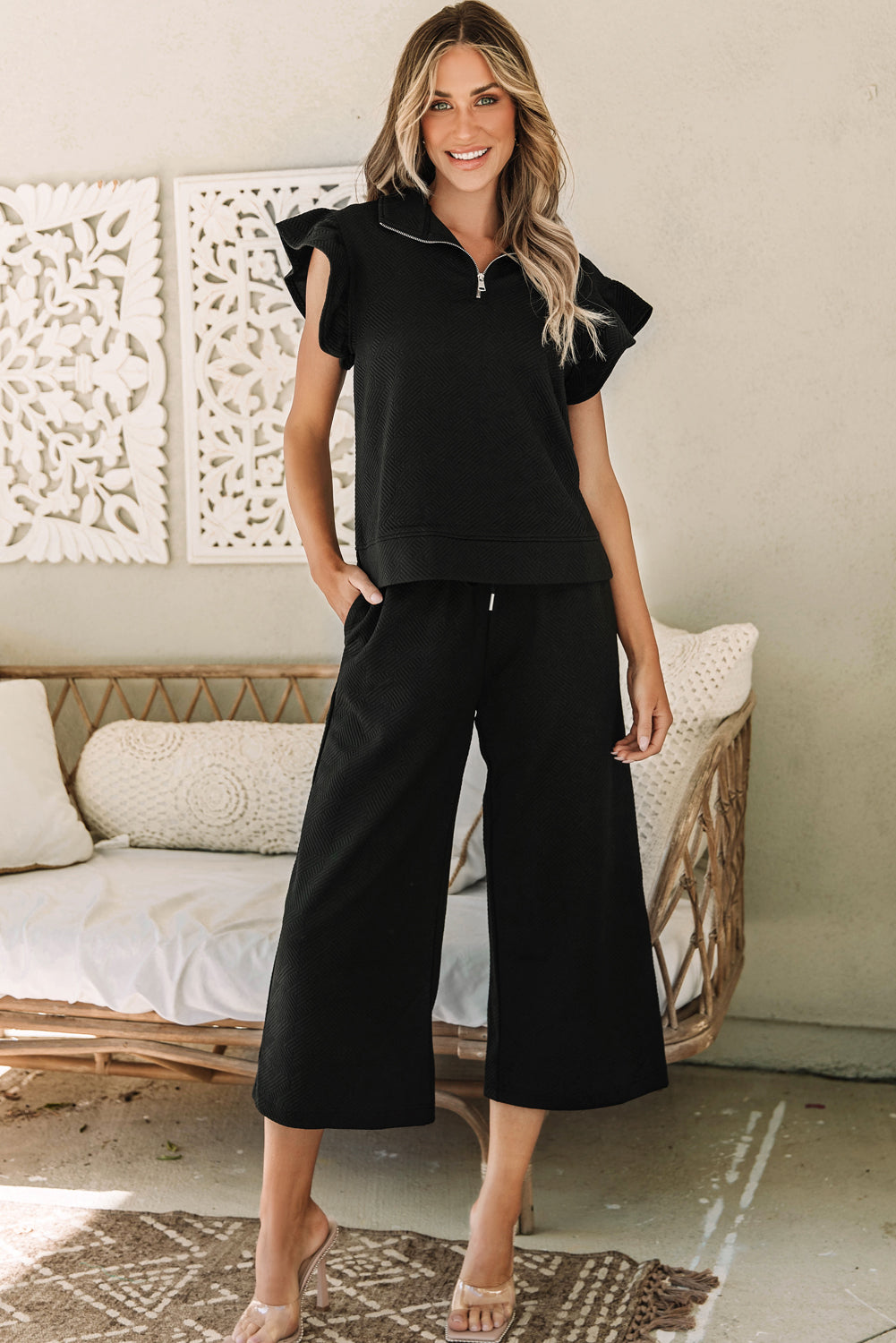 Black textured top and wide leg pants set with flutter sleeves