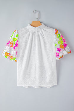 White textured high with smocked neck and sequined flowers and puffy sleeves