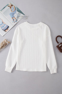 White textured knit top with crew neck and dropped shoulders