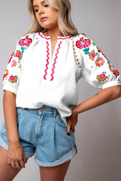 White textured blouse with puffy sleeves and Ricrac floral embroidery