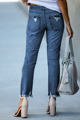 Jean bleu foncé à taille élastique, jambe droite, ourlet brut détruit