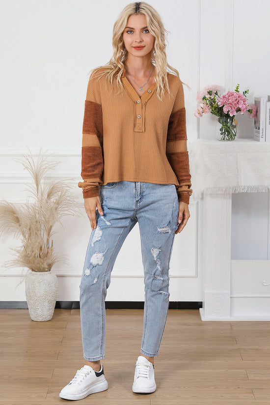 Waffle knit henley top with exposed seams and orange contrast patches