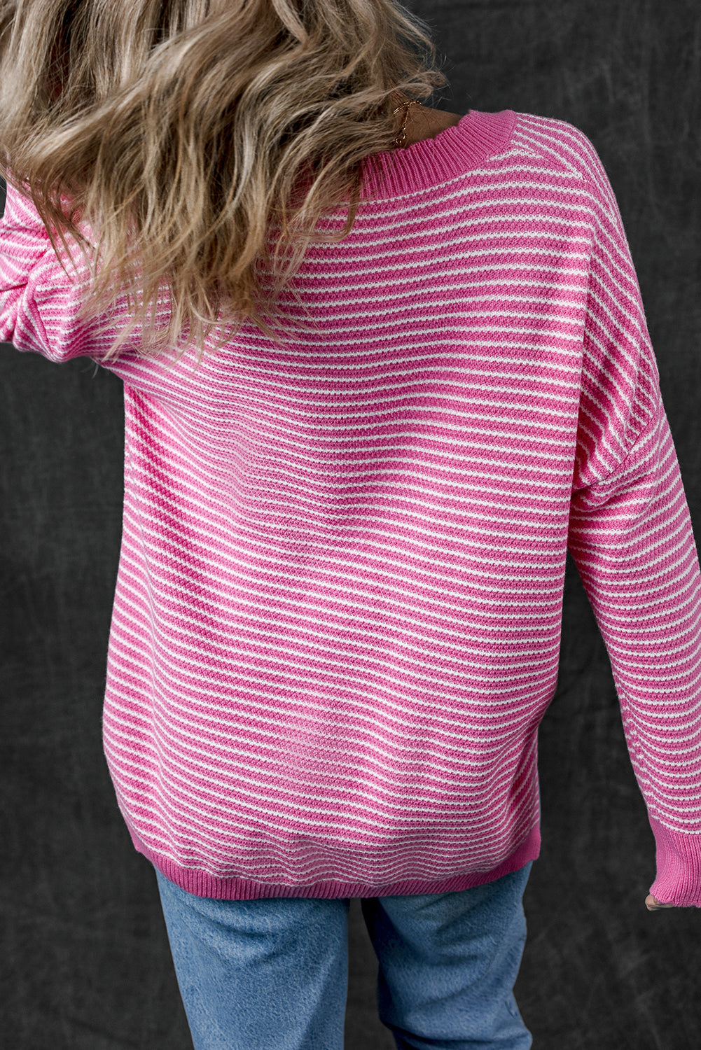 Loose V-neck sweater with pink striped slits