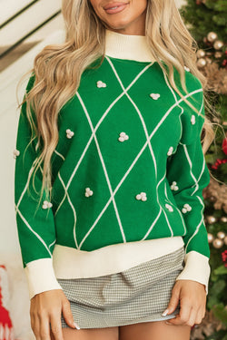 High collar sweater with dark green diamond pattern with pompom accents and contrasting border