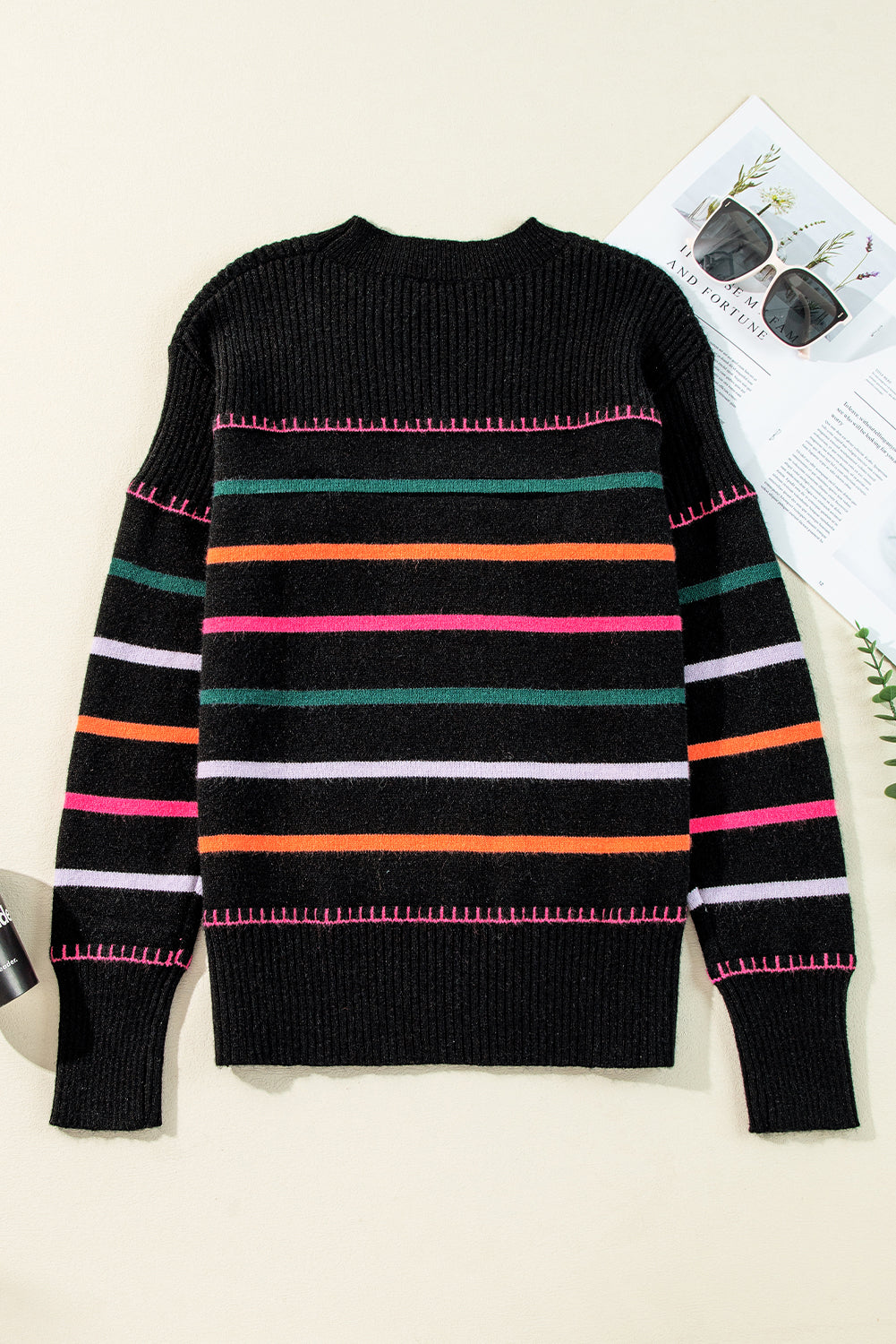 Black sweater with ribbed edges and colorful stripes