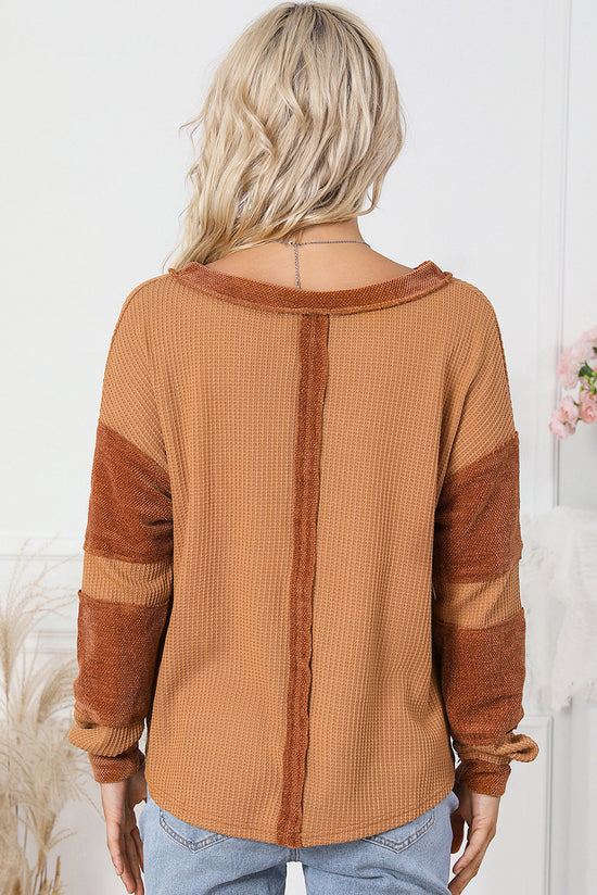 Waffle knit henley top with exposed seams and orange contrast patches