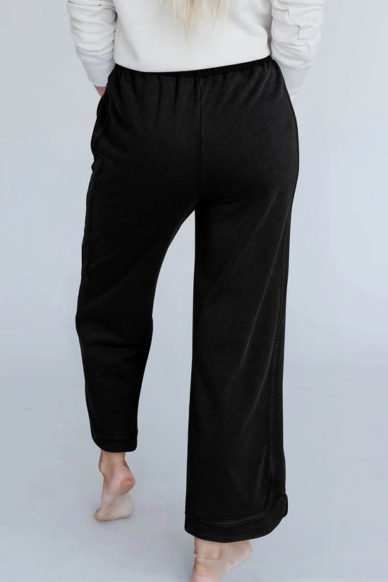 Pantalon large noir à délavage minéral et coutures apparentes