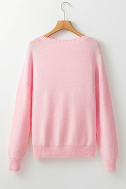 Pink knitted sweater with ribbed edges and flower pattern