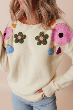 Beige knitted sweater with ribbed edges with flower pattern