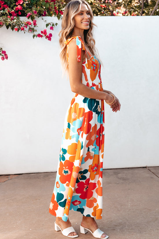 Long orange floral dress with straps tied at the smocked bust