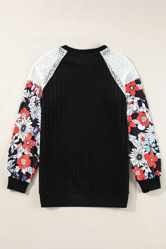 Black ribbed blouse with long sleeves and floral patchwork