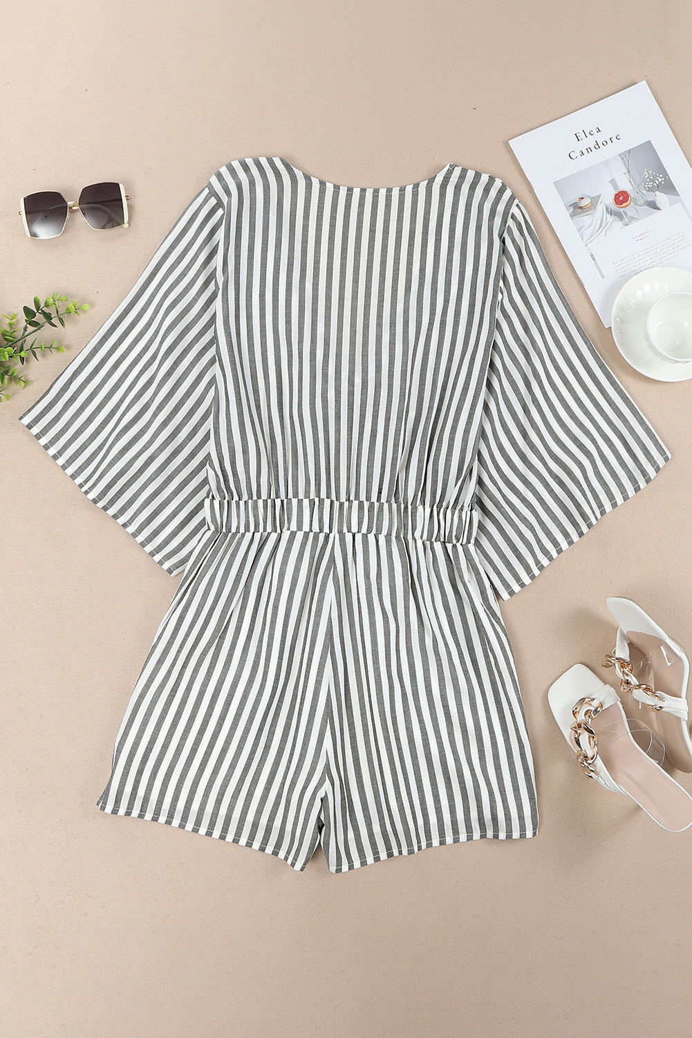 Grey striped romper with 3/4 wide sleeves and knotted front with pockets