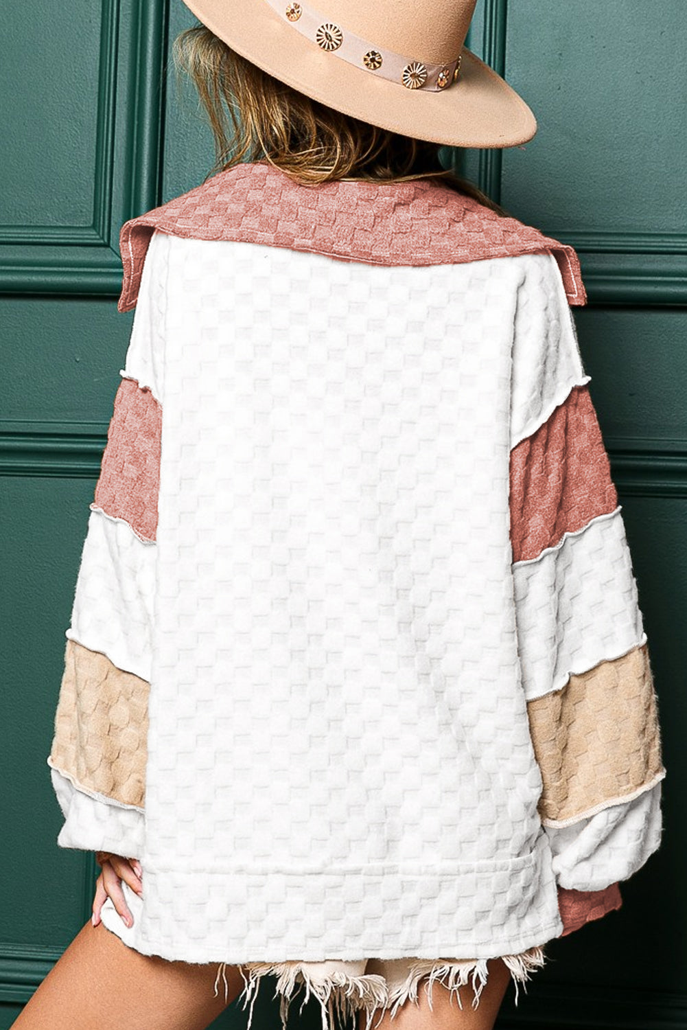 Loose-fitting white plaid top with exposed seams, V-neck