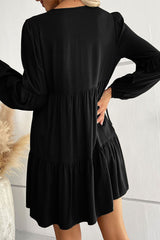 Black lace mini dress with puff sleeves and ruffles and buttons