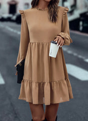 Tiered dress with ruffled shoulders and ruffled collar in light French beige
