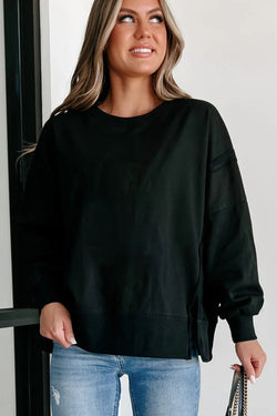 Black sweatshirt with exposed seams, dropped shoulders, round neck, slits