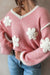 Sweater rosa de hombro rosado y cuello en forma de V en forma de V