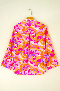 Pink blouse with abstract print and paw sleeves and notched neck