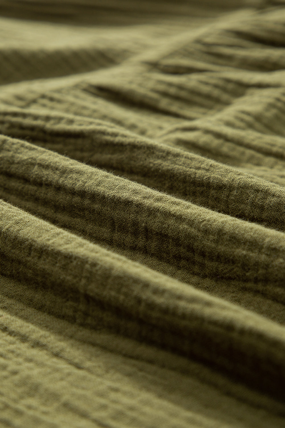 Green flared dress with frayed edging, split collar, puffed sleeves
