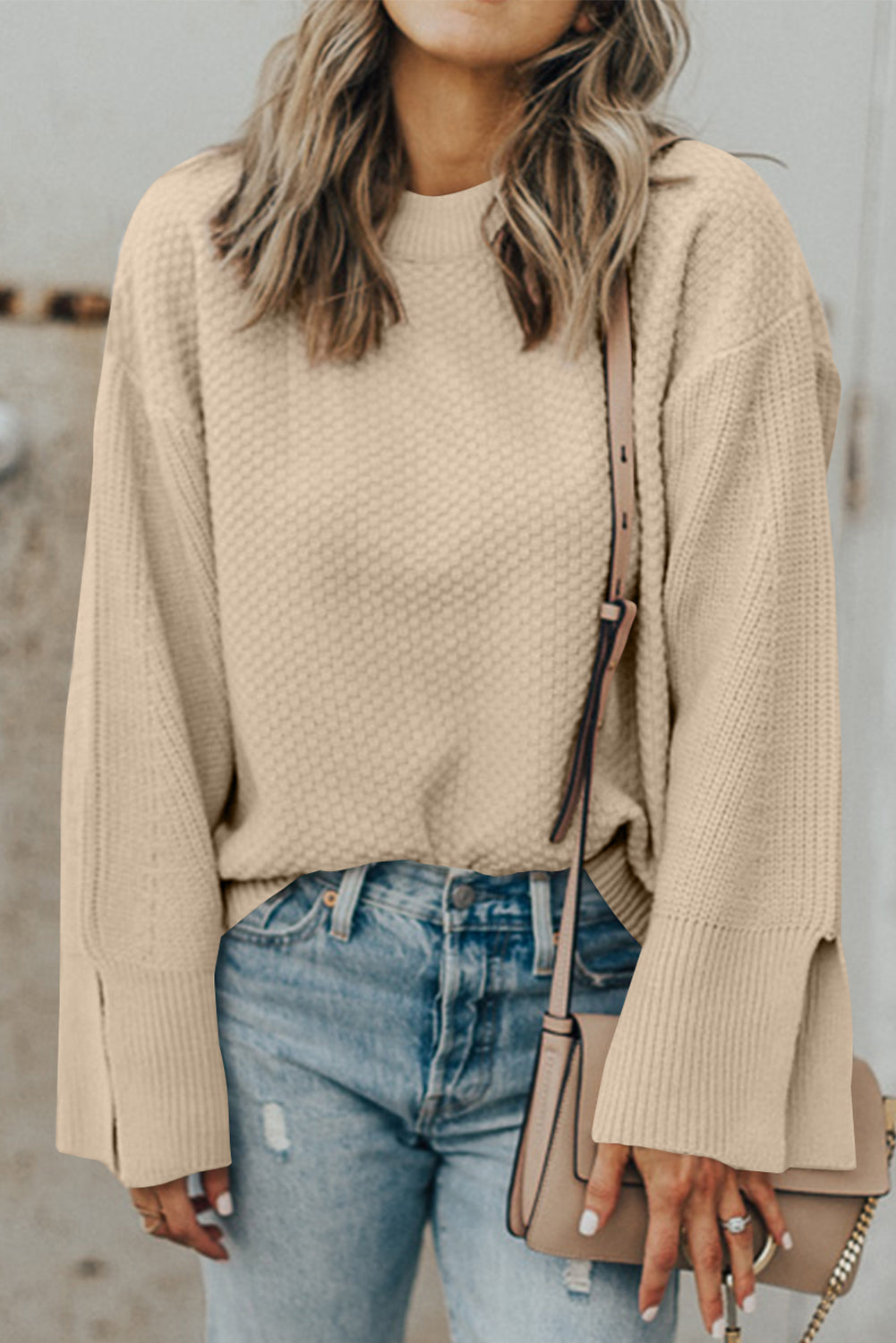 Loose-fitting parchment textured knit sweater with slit cuffs and dropped shoulders