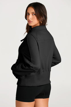 Black sweatshirt with stand-up collar and kangaroo pocket with quarter-turn zip