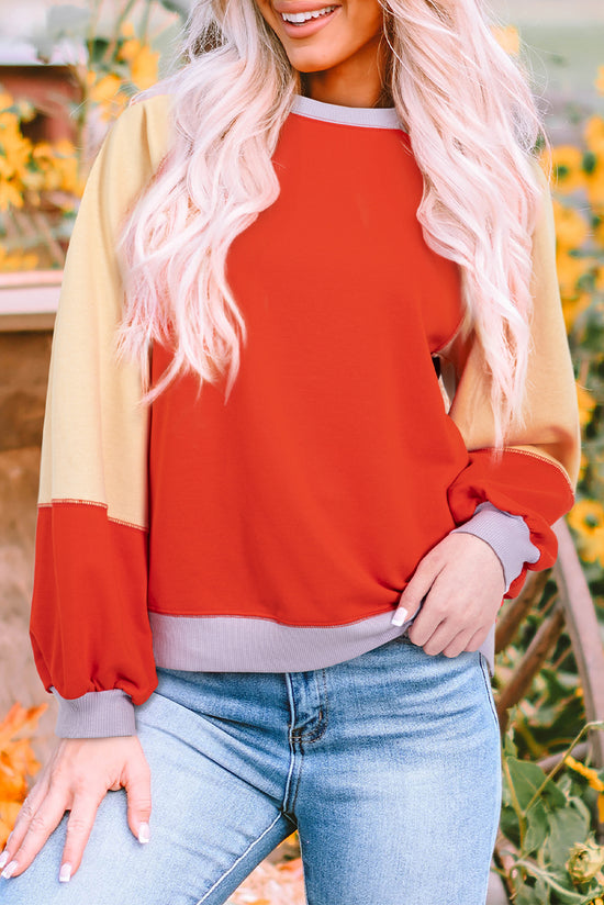 Orange raglan sleeve loose top with side slits and color blocking