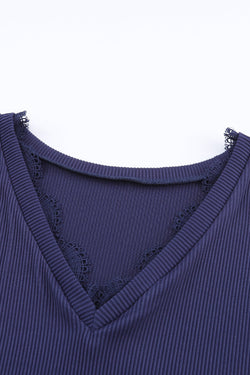 Blue long sleeve v-neck top with lace trim and ribbed texture