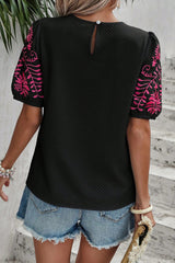 Black t-shirt with puffy textured sleeves embroidered with flowers