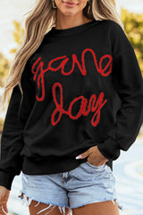 Sudadera gráfica negra con hombros caídos Día del juego de oropel