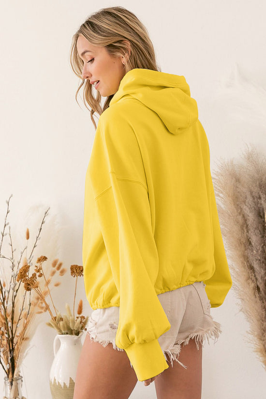 Yellow zip-up hoodie with kangaroo pocket and ribbed trim