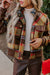 Brown jacket with printed tiles with chest pockets and buttons zipper and upright collar