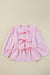 Striking pink blouse and bow tie on the front, round neck, puffy sleeves