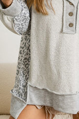 Gray Sweatshirt with buttoned collar and exposed seams in leopard patchwork