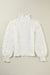 White textured top with puff sleeves and smocked mock neck